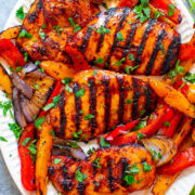 Grilled Sriracha Spicy BBQ Chicken and veggies on a plate.