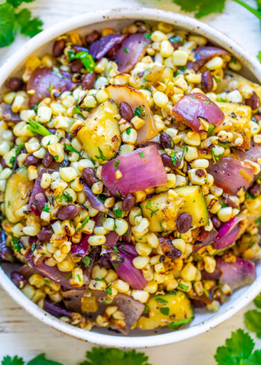 Grilled Corn and Black Bean Salad - An EASY corn salad with black beans, zucchini, red onions, cilantro, lime juice, and more!! So much Mexican-inspired FLAVOR in every bite of this family favorite recipe that's sure to be a hit!!