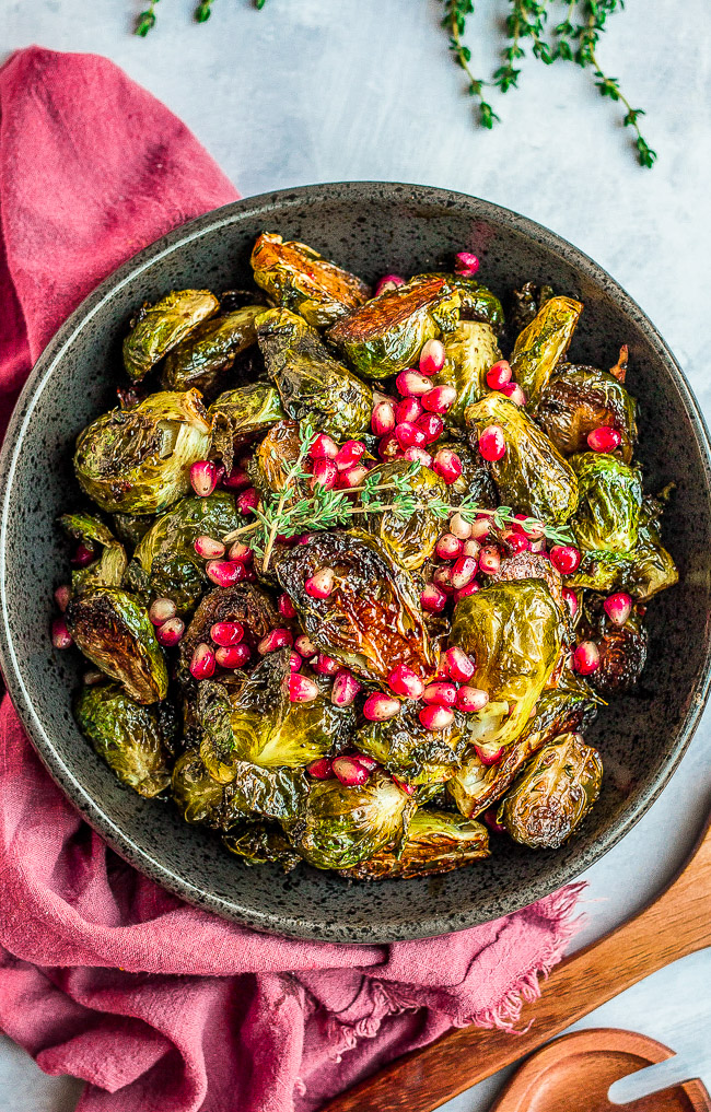 Balsamic Glazed Brussels Sprouts with Pomegranate Seeds - An easy side dish that's perfect for not only the holidays but anytime you're in the mood for CRISPY roasted Brussels sprouts!! The homemade balsamic glaze seeps into every inch of the spouts and adds so much tangy-sweet flavor!! 