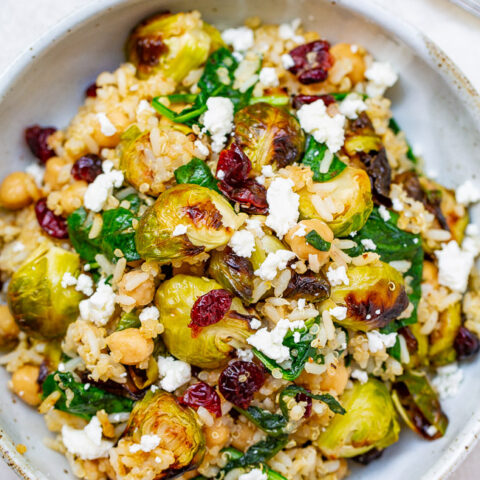 Roasted Brussels Sprouts Quinoa Chickpea Salad - A HEARTY salad that celebrates the flavors of fall including roasted Brussels sprouts and dried cranberries along with quinoa, chickpeas, spinach, and goat cheese!! Perfect for lunch, a meatless main, or a HEALTHY side dish on your holiday table!!