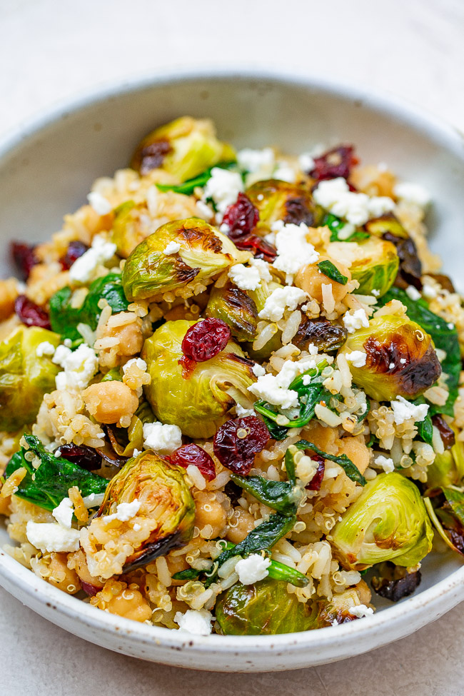 Roasted Brussels Sprouts Salad — A HEARTY salad that celebrates the flavors of fall including roasted Brussels sprouts and dried cranberries along with quinoa, chickpeas, spinach, and goat cheese!! Perfect for lunch, a meatless main, or a HEALTHY side dish on your holiday table!!