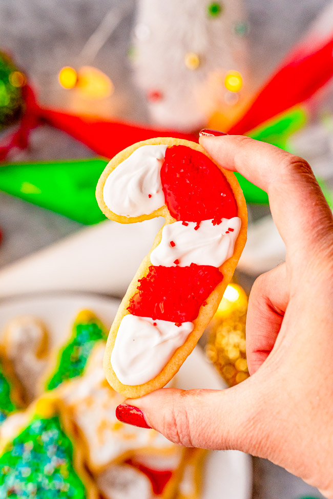Christmas Cut Out Cookies — These traditional cut out sugar cookies are just like Grandma used to make!! They're thin but still soft, topped with a simple 2-ingredient royal icing, and loaded with sprinkles! So festive and perfect for cookies exchanges or hostess gifts!!