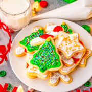Christmas Cut Out Sugar Cookies - These traditional sugar cookies are just like Grandma used to make!! They're thin but still soft, topped with a simple 2-ingredient royal icing, and loaded with sprinkles! So festive and perfect for cookies exchanges or hostess gifts!!