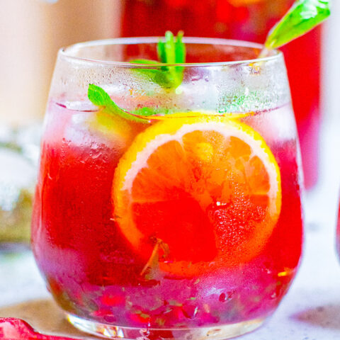 Pomegranate Mojito Punch - A FESTIVE twist on a classic mojito complete with pomegranate juice and pom arils while retaining plenty of fresh mint and of course the rum!! Fast, easy, SO TASTY, and perfect for holiday entertaining!! 