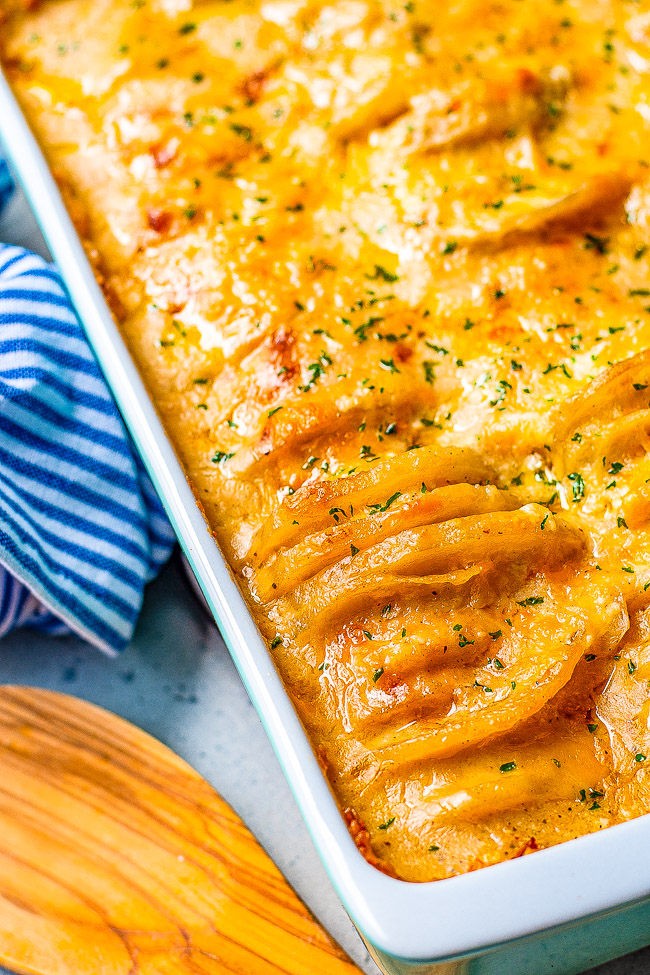 Scalloped Potatoes with Cheese — These baked scalloped potatoes are EXTRA cheesy thanks to three cheeses used as well as super rich and CREAMY!! They're a perfect HOLIDAY SIDE DISH as well as family friendly weeknight COMFORT FOOD!