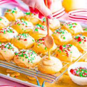 Eggnog Teacakes being topped with eggnog glaze and festive sprinkles.