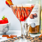 Chocolate Covered Strawberry Martini in a glass with a chocolate covered strawberry on the rim.