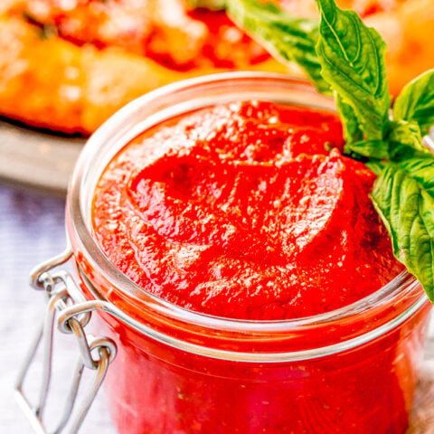 Homemade Pizza Sauce - A no-cook, no-blender recipe for homemade pizza sauce that's ready in five minutes!! Simply whisk the ingredients together and get ready to enjoy pizza sauce that's BURSTING with flavor! Once you see how EASY this is, you'll never need the store bought kind again!!