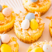Mini Easter Cheesecakes topped with Cadbury eggs and coconut.