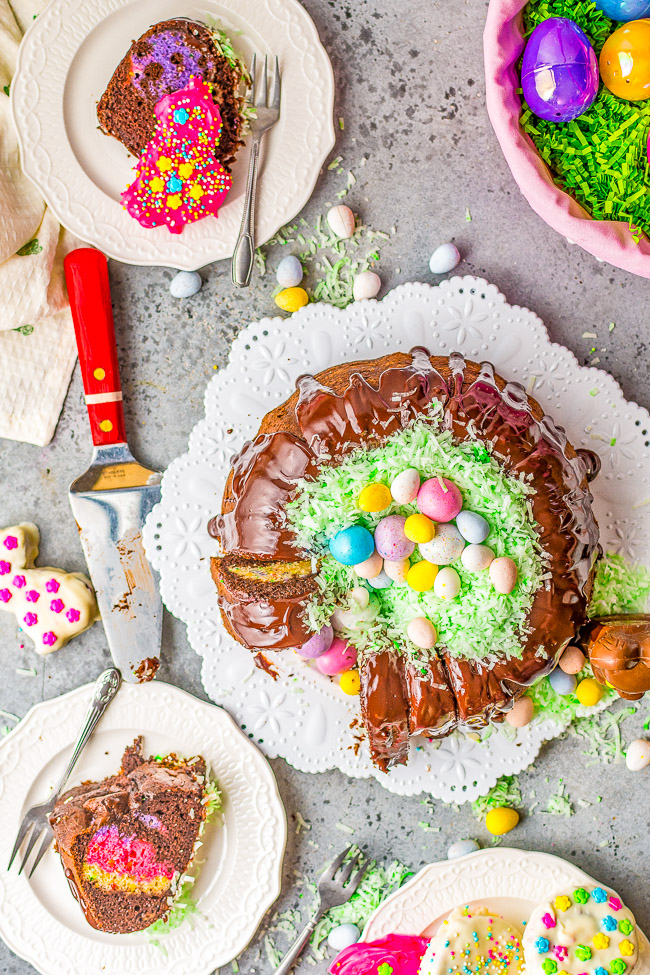Easter Egg Treasure Cake - This FUN cake is made with two different cake mixes. The eggs, chicks, and bunnies from the first cake are cut out and put in the second cake before it's baked.  Decorated with coconut grass and candy eggs, this is a FESTIVE Easter dessert with buried TREASURES inside!!  Use the leftover cake to cut out more mini cakes and let the kids decorate for extra fun!