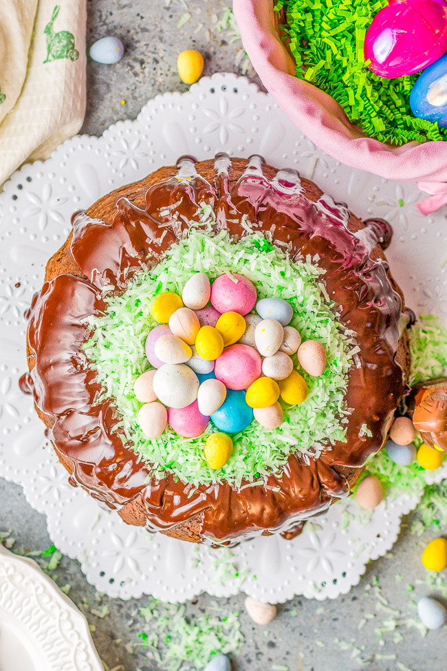 Easter Egg Treasure Cake - This FUN cake is made with two different cake mixes. The eggs, chicks, and bunnies from the first cake are cut out and put in the second cake before it's baked.  Decorated with coconut grass and candy eggs, this is a FESTIVE Easter dessert with buried TREASURES inside!!  Use the leftover cake to cut out more mini cakes and let the kids decorate for extra fun!