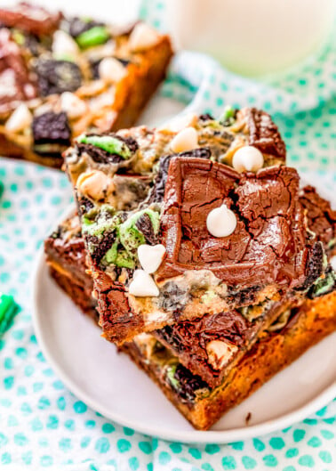 Mint Magic Bars - These bars are a mint twist on the classic Seven Layer Bars many grew up with! Made with Ghirardelli Mint Chocolates, Andes Mints, and Mint Oreos on a chocolate chip cookie base. White chocolate chips, chocolate chunks, and a layer of sweetened condensed milk that caramelizes as it bakes provide a true Magic Bar experience!