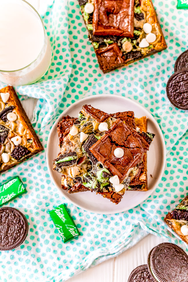 Loaded Mint Chocolate Chip Cookie Bars — These bars are a mint twist on the classic Seven Layer Bars many grew up with! Made with Ghirardelli Mint Chocolates, Andes Mints, and Mint Oreos on a chocolate chip cookie base. White chocolate chips, chocolate chunks, and a layer of sweetened condensed milk that caramelizes as it bakes provide a true Magic Bar experience!