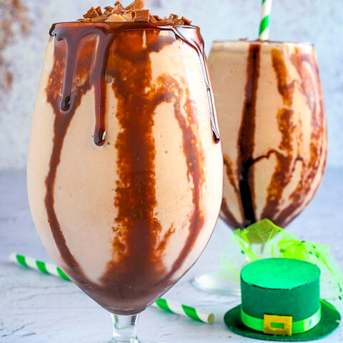 Frozen Irish Mudslide - These frozen mudslides are decadent dessert-like drinks made with three types of alcohol - Irish whiskey, Baileys Irish Cream, and Kahlua - for a slightly boozy milkshake with an abundance of chocolate syrup! Perfect for St. Patrick's Day or a warm weather treat to cool you down! 