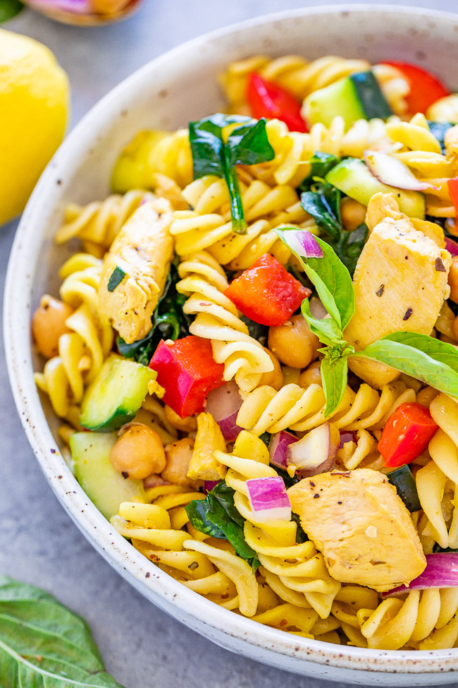 Mediterranean Lemon Chicken Pasta Salad - This chicken pasta salad is loaded with flavor, ready in minutes, and showcases Mediterranean-inspired ingredients! It’s perfect for summer potlucks and barbecues (no mayo!) and feeds a crowd. Or make it as an EASY family dinner with planned leftovers!