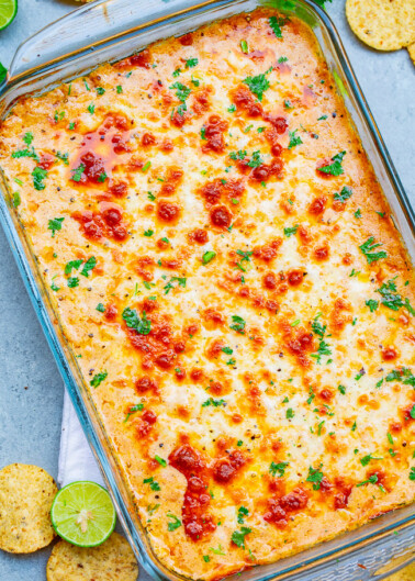 Mexican Baked Cheesy Street Corn Dip - A hot corn dip reminiscent of Mexican street corn!! Creamy, cheesy, spiked with lime juice, chili powder, and a serrano chile or jalapeno for a touch of heat! SO EASY and ready in 20 minutes!! Perfect for parties, potlucks, tailgating, or your next FIESTA!! 
