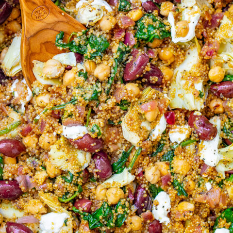 Mediterranean Quinoa and Chickpea Salad - This EASY quinoa salad is ready in 20 minutes with Mediterranean-inspired ingredients including chickpeas, Kalamata olives, artichokes, and goat cheese to give layers of flavor and texture in every bite! Naturally gluten-free and vegetarian!