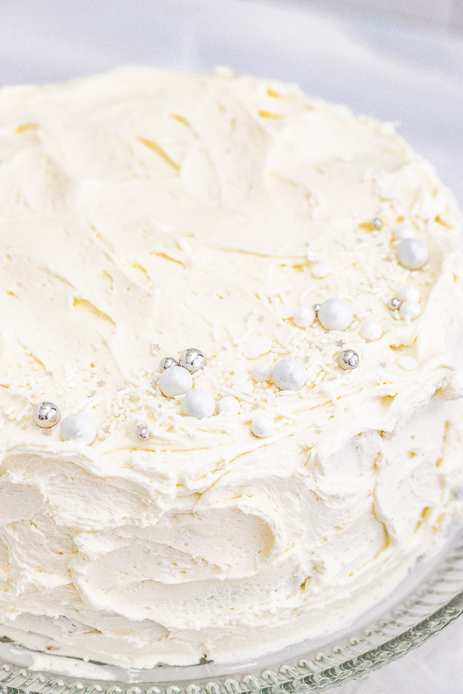 White Layer Cake - A classic, white, two-layer cake recipe for cake with a light texture that's complemented by super light and fluffy buttercream that's not too sweet! Learn how to make THE BEST white layer cake that's fancy enough to serve at your most special celebrations and events!