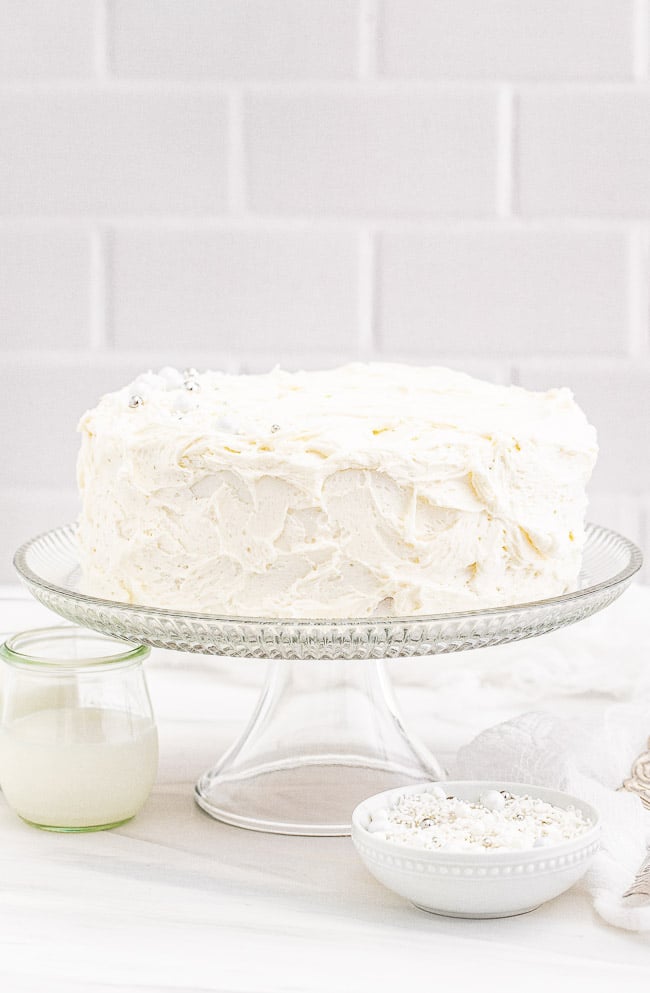White Layer Cake - A classic, white, two-layer cake recipe for cake with a light texture that's complemented by super light and fluffy buttercream that's not too sweet! Learn how to make THE BEST white layer cake that's fancy enough to serve at your most special celebrations and events!