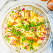 German Potato Salad - A classic potato salad made with tender red potatoes, bacon, onions, and a tangy dressing! This no-mayo potato salad is a family favorite side dish that's perfect for parties, picnics, and potlucks!!