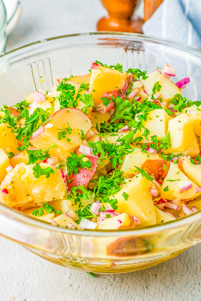 German Potato Salad - A classic potato salad made with tender red potatoes, bacon, onions, and a tangy dressing! This no-mayo potato salad is a family favorite side dish that's perfect for parties, picnics, and potlucks!!