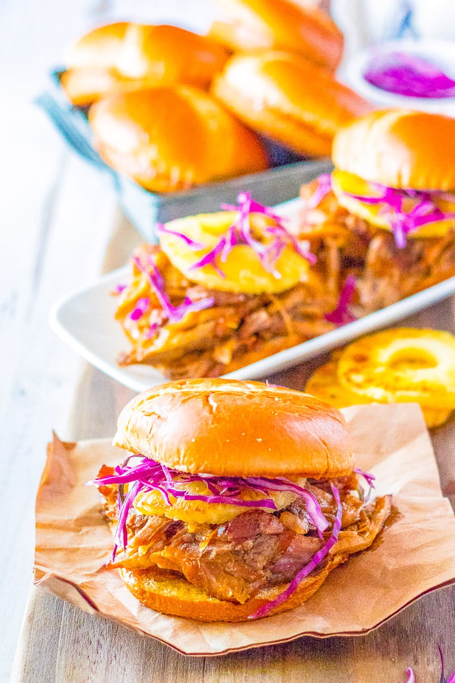 Slow Cooker Hawaiian Pulled Pork - Pork is slow cooked to perfection and has Hawaiian-inspired flavors from pineapple and teriyaki sauce! Sweet, tangy, tender, and juicy! It makes the best pulled pork sandwiches that everyone loves!