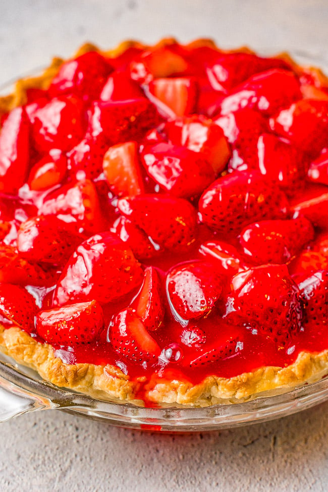 Fresh Strawberry Pie - This EASY strawberry pie is bursting with juicy, fresh strawberries and covered in a delicious glaze! Use a homemade flaky crust OR a refrigerated store bought crust for this amazing pie that everyone LOVES! Only SIX main ingredients!