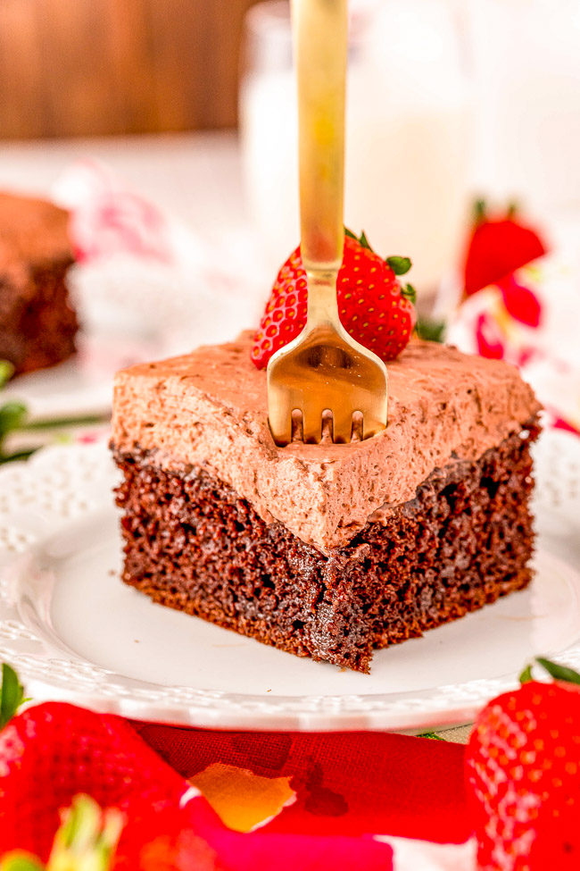 Chocolate Poke Cake - A FAST and EASY cake that's perfect for all the chocaholics! Moist and tender chocolate cake, filled with chocolate syrup, and topped with whipped chocolate frosting! A no-fuss chocolate cake that everyone will adore!