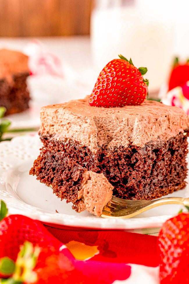 Chocolate Poke Cake - A FAST and EASY cake that's perfect for all the chocaholics! Moist and tender chocolate cake, filled with chocolate syrup, and topped with whipped chocolate frosting! A no-fuss chocolate cake that everyone will adore!