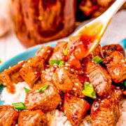 A bowl of white rice topped with teriyaki steak bites.