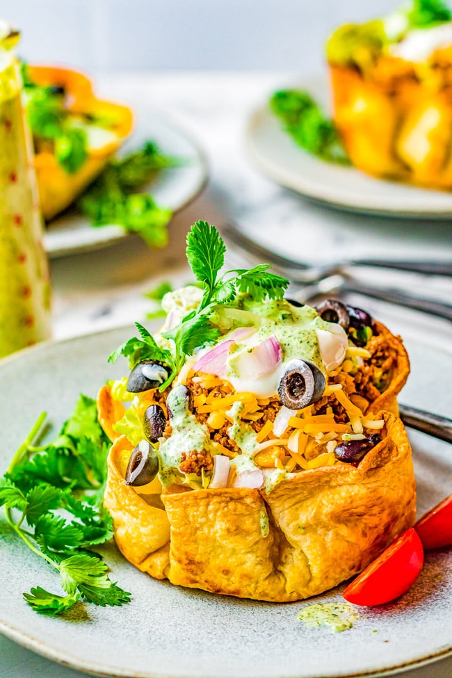 Beef Taco Salad Bowls – Making homemade taco salad bowls is so easy and they’re perfect for holding this family-favorite taco salad including seasoned ground beef, black beans, cheese and more! Everything is topped with a creamy lime-cilantro dressing that’ll have everyone finishing their salad!
