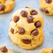 OlIve oil chocolate chip cookies on a countertop, two stacked on top of each other.