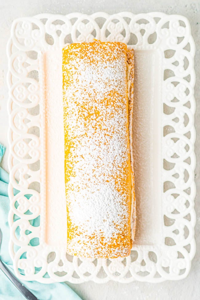 Pumpkin Roll - With my EASY pumpkin roll recipe and clear specific directions,  you're going to be a pumpkin roll pro! No dish towel required to roll up my classic pumpkin roll cake that's full of rich pumpkin spice flavor and tangy cream cheese frosting! A fall favorite that all pumpkin fans will just ADORE! Freezes well and makes a great hostess gift! 