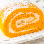 Pumpkin Roll with cream cheese frosting topped with powdered sugar.