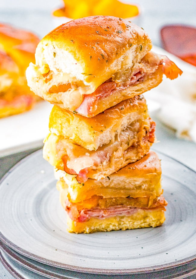 Hawaiian Ham and Swiss Sliders — Grilled pineapple slices brushed with a soy and ginger marinade add a Hawaiian-inspired twist to these irresistible sandwiches! Juicy ham, melted Swiss cheese, and melted butter are impossible to resist! FAST, EASY, perfect as a game day or party appetizer, snack, or quick weeknight dinner!