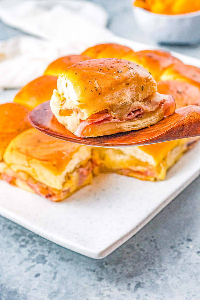 Hawaiian Ham and Cheese Sliders - Grilled pineapple slices brushed with a soy and ginger marinade add a Hawaiian-inspired twist to these irresistible sandwiches! Juicy ham, melted Swiss cheese, and melted butter are impossible to resist! FAST, EASY, perfect as a game day or party appetizer, snack, or quick weeknight dinner!