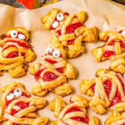 Mummy hand pies on a baking sheet.