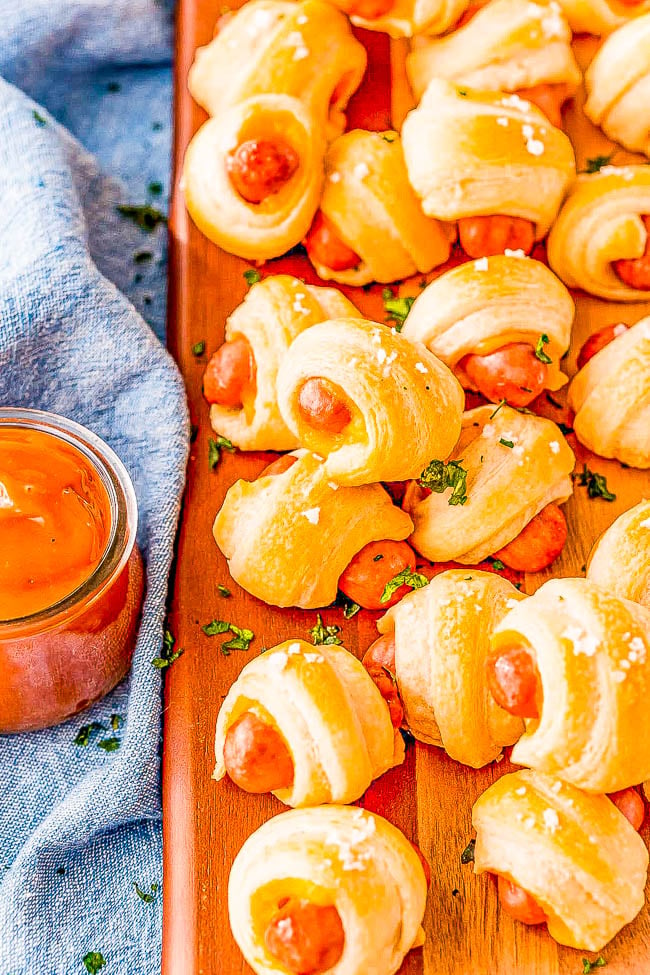 Cheddar Pigs In A Blanket - Sliced cheddar cheese and flaked salt takes this classic game day recipe and turns up the flavor! A FAST and EASY appetizer for holiday parties, get-togethers, or events! Along with the easy whisk-together dipping sauce, I promise you there won't be any left over!