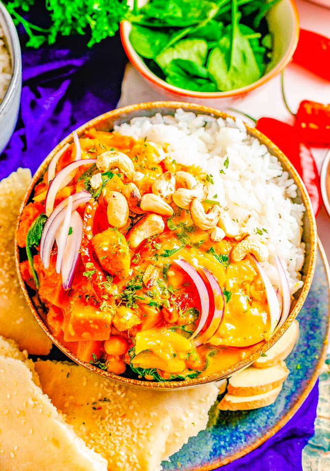 Thai Pumpkin Chickpea Coconut Curry - An EASY curry that's ready in 30 minutes! Tender fresh pumpkin, chickpeas, bell peppers, spinach, and more all bathed in the most aromatic Thai-inspired coconut milk broth! If you love Thai food, skip the restaurant and make this better-than-takeout curry at home!