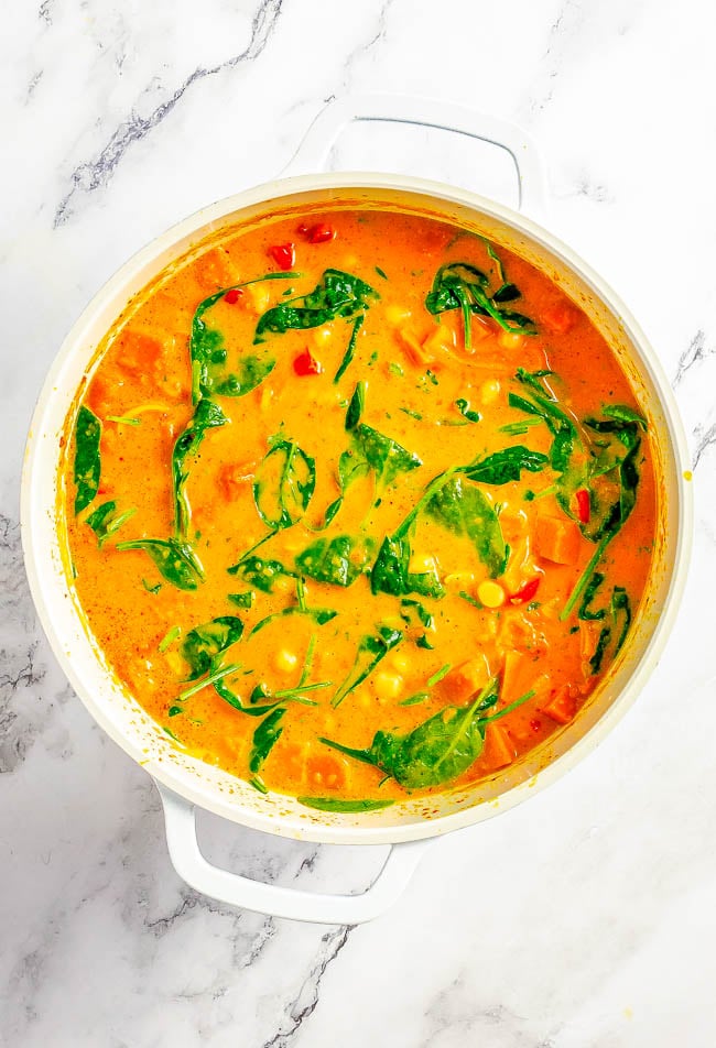 Thai Pumpkin Chickpea Coconut Curry - An EASY curry that's ready in 30 minutes! Tender fresh pumpkin, chickpeas, bell peppers, spinach, and more all bathed in the most aromatic Thai-inspired coconut milk broth! If you love Thai food, skip the restaurant and make this better-than-takeout curry at home!