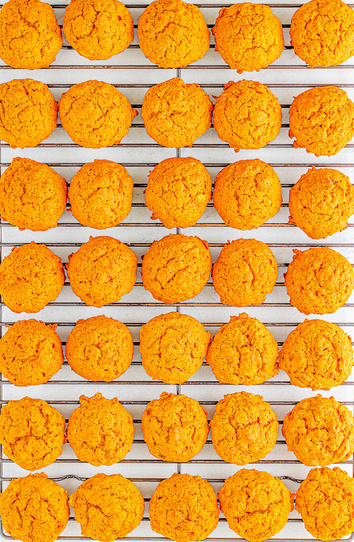 Rows of freshly baked golden cookies cooling on a wire rack.