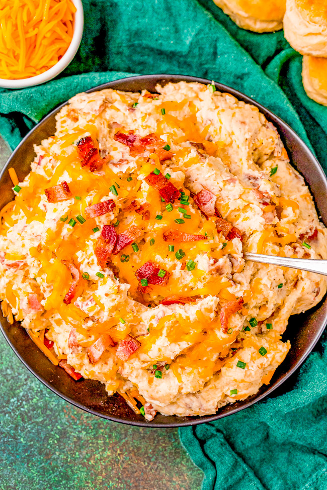 Loaded Bacon Cheddar Mashed Potatoes - If you like loaded baked potatoes, you'll LOVE these mashed potatoes loaded with bacon, cheddar cheese, butter, sour cream, and more! A family-favorite side dish that's perfect for weeknight dinners or holiday celebrations. Irresistible, EASY comfort food! 