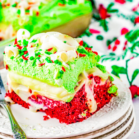 Christmas Red Velvet Poke Cake - The EASIEST and most impressive Christmas cake! You'll have your friends and family thinking you're a rock star pastry chef! Moist red velvet cake is infused with white chocolate pudding, topped with whipped topping, sprinkles, and white chocolate curls! Ready in ONE HOUR and uses shortcut ingredients to make your job as easy and hassle-free as possible! 