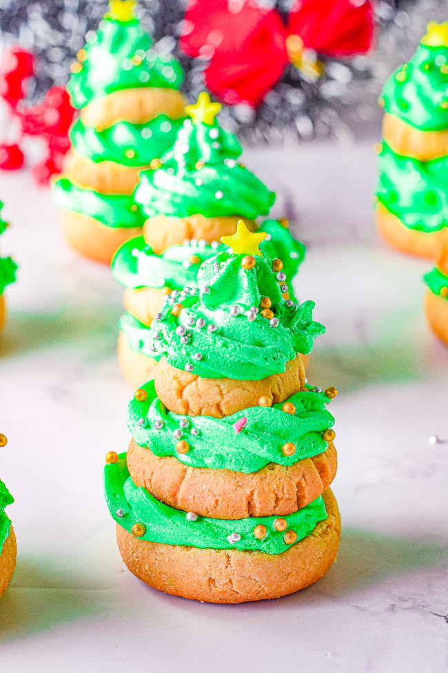 Stacked Christmas Tree Cookies - Softy, chewy, buttery sugar cookies are stacked in the shape of Christmas trees and layered with buttercream frosting! Fun and festive for the holidays and EASY to make! No need to roll out the dough nor chill it. A great holiday cookie to make with kids!