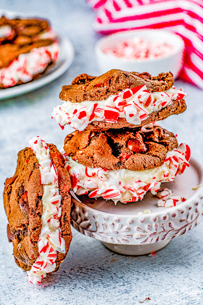 Double Chocolate Peppermint Sandwich Cookies - Rich, decadent, soft and chewy double chocolate cookies are sandwiched together with a tangy cream cheese filling. Rolled in crushed candy canes and drizzled with white chocolate for extra flavor and holiday festiveness! They're the PERFECT Christmas cookie! 