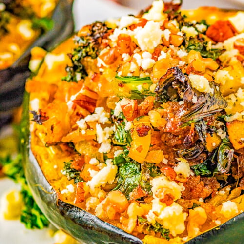 A stuffed acorn squash half with sausage and apple.