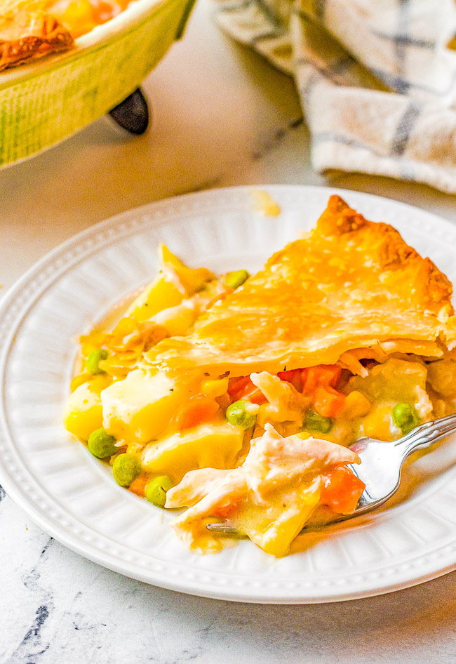 Turkey Pot Pie - Hearty, creamy, comforting, perfect for chilly weather, and EASY to make! Use leftover shredded TURKEY OR CHICKEN in this homemade pot pie recipe loaded with potatoes, carrots, celery, peas, and juicy chunks of meat. Use store bought refrigerated pie crust and a shredded rotisserie chicken to save even more time!