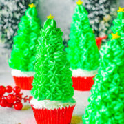 Christmas Tree Cupcakes - Vanilla cupcakes are turned into festive Christmas trees with the help of inverted ice cream cones that are decorated with green whipped cream! An no-mixer, one-bowl cupcake recipe that's so EASY! Perfect on your holiday dessert table or served at your next Christmas party. Detailed instructions provided to help make these Christmas tree cupcakes suitable for even novice bakers.