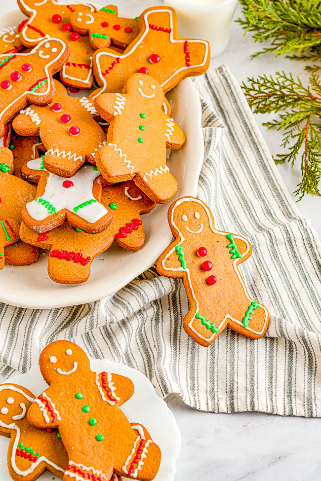 Classic Chewy Gingerbread Cookies — Soft and chewy cut-out gingerbread cookies filled with plenty of ginger and warming spices! Decorated with a sweet, soft royal icing and topped with cinnamon candies, these gingerbread men are a nostalgic favorite Christmas cookie that everyone adores! 