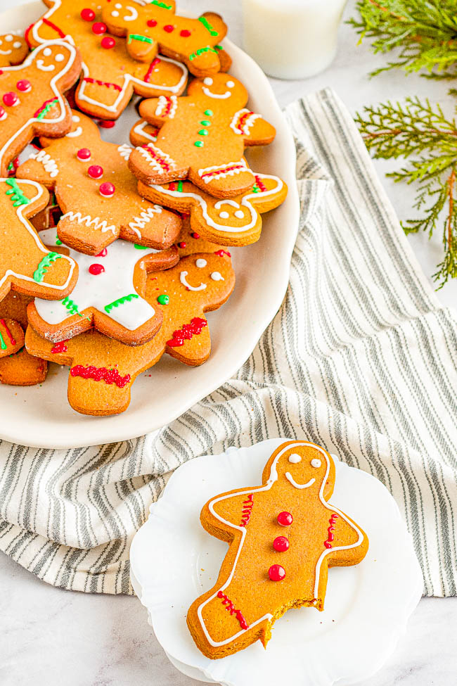 Classic Gingerbread Cookies - Soft and chewy cutout gingerbread cookies filled with plenty of ginger and warming spices! Decorated with a sweet, soft royal icing and topped with cinnamon candies, these gingerbread men are a nostalgic favorite Christmas cookie that everyone adores! 